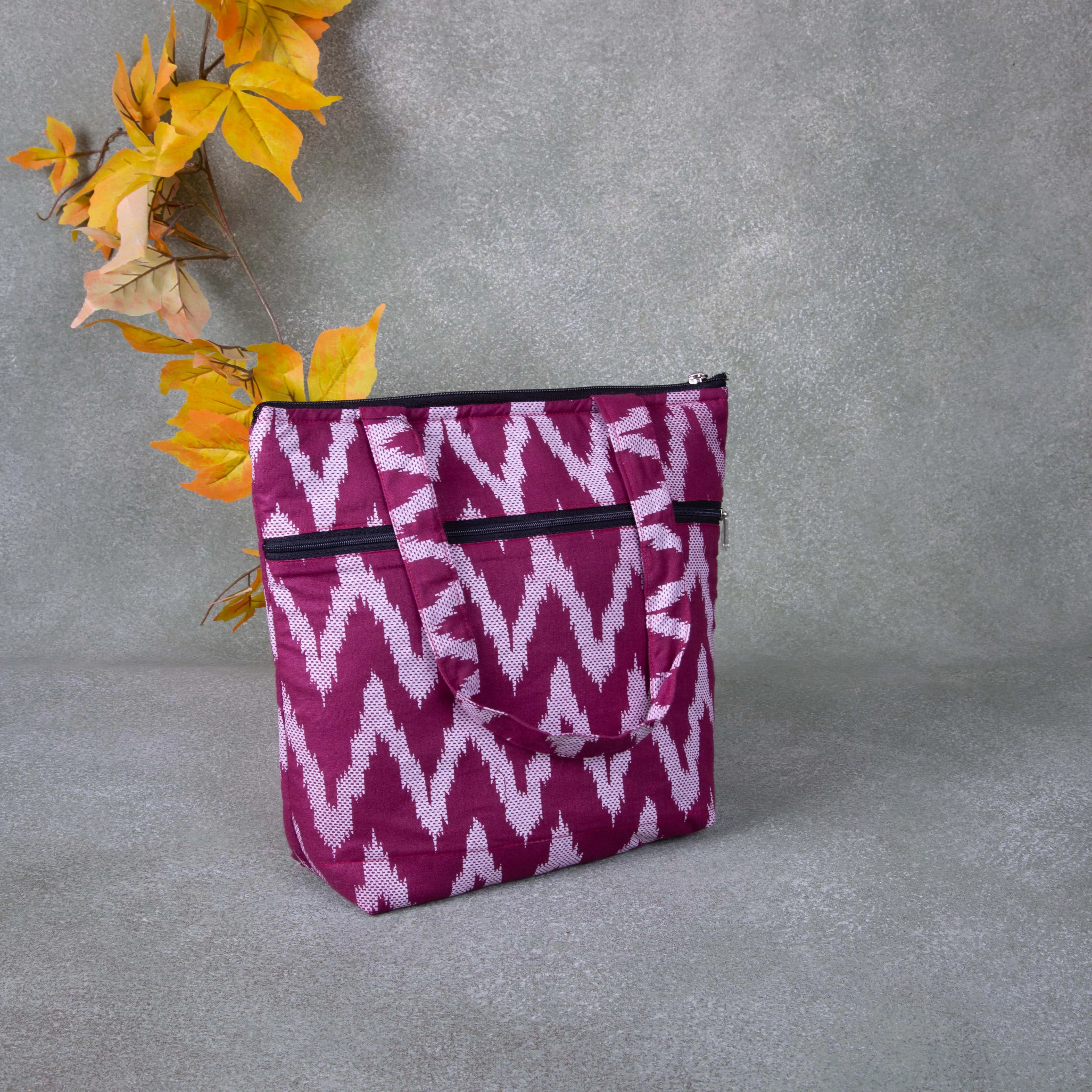 Small Handbag wine colour with white zig zag Design.